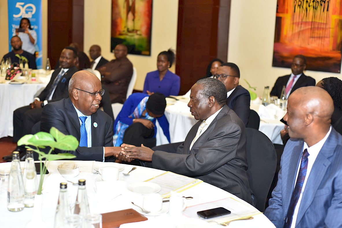 Hon. Matia Kasaija, Uganda’s Minister of Finance, Planning & Economic Development shakes hands with Dr. James Tumusiime, board member EADB as Dr. Ramathan Ggoobi, Permanent Secretary, Ministry of Finance, Planning & Economic Development looks on.